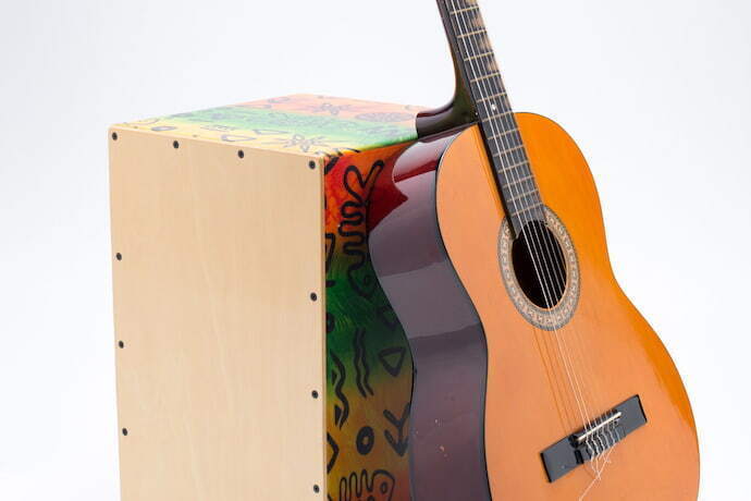 Cajon com violão apoiado.