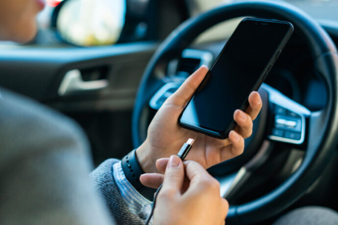 Homem carregando um dispositivo no carro